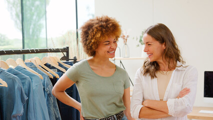 Two Laughing Women Friends Running Online Fashion Business From Home Together