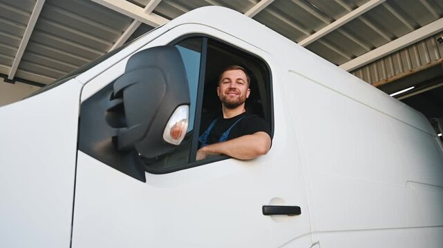 Sitting in a van and smiling. Courier of delivery service company is at work - Powered by Adobe