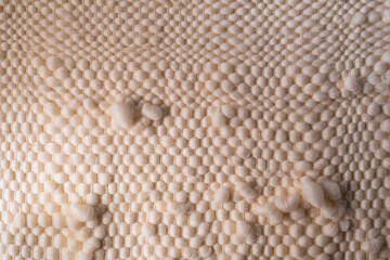 Natural fluffy beige textile with a rough texture