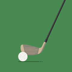 Golf club poised to strike a golf ball on a green surface.