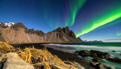 Majestic Aurora Borealis Over Stokksnes Mountains and Black Sand Beach with Golden Grass Iceland Nightscape