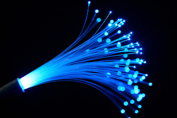 Abstract Glowing Blue Fiber Optic Strands Light Trails on Black Background