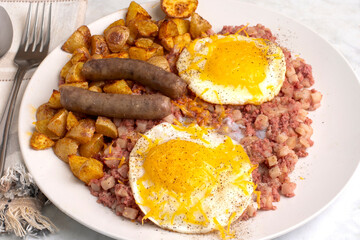 fried eggs  on corn beef hash