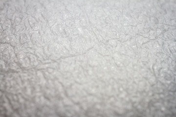 Extreme macro of plastic bubble wrap texture. Selective soft focus, shallow depth of field. Abstract dreamy background
