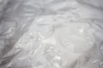 Extreme macro of plastic bubble wrap texture. Selective soft focus, shallow depth of field. Abstract dreamy background