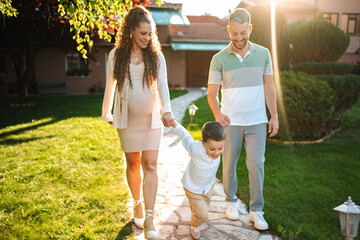 Family stroll in the garden during golden hour light
