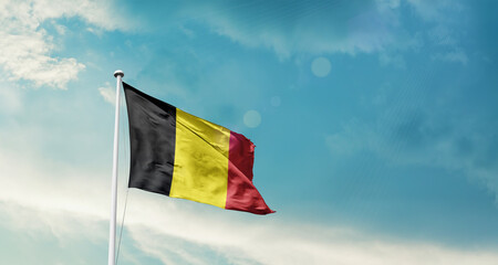 Belgium national flag fluttering. The flag blowing in beautiful soft sky. Belgium national flag for independence day.
