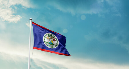 Belize national flag fluttering. The flag blowing in beautiful soft sky. Belize national flag for...