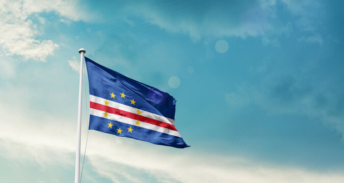 Cabo Verde national flag fluttering. The flag blowing in beautiful soft sky. Cabo Verde national flag for independence day.