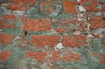 Background of an old brick wall with traces of gray cement