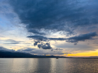 Scenic View of Lake with Cloudy Sky at Sunset