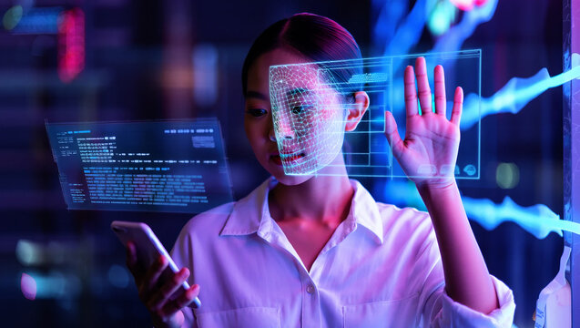Woman interacting with holographic face scan and data technology