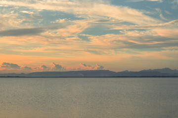 Calm Lakeside with Mountain Range at Sunset