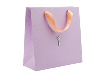 Lilac gift bag with peach ribbon handles and silver key isolated, elegant present for special occasions and celebrations