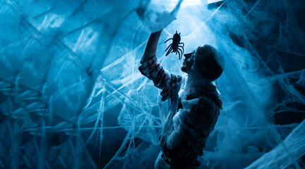 Silhouette scary man with spider in mouth into Creepy white spider web on black background