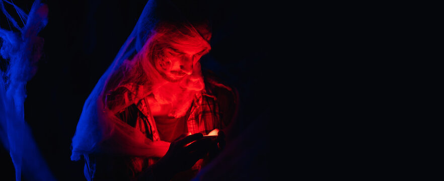 Halloween man zombie in spiderweb. Satan, danger concept. Devil dead man. Banner. - Powered by Adobe