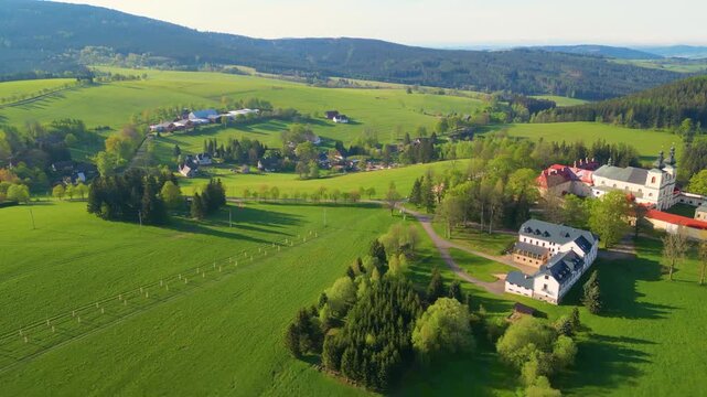 Explore the serene landscapes surrounding the Church of the Assumption of the Virgin Mary on Mother of God Mountain, a significant monastery and pilgrimage site in Kraliky, Czechia.