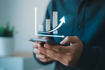 Close up of a person using a smartphone with a rising bar graph representing business growth and financial success for mobile banking and investment apps