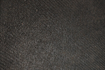 Dark textured fabric background closeup – black woven textile pattern, abstract surface detail for design, wallpaper, or digital backdrop.