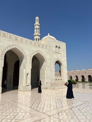 ladies taking a photo at the Sultan Qaboos Grand Mosque