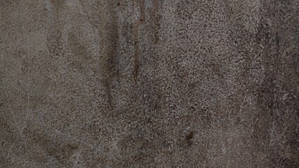 A close-up of the brown leather surface with its rough texture provides an aged and dirty background pattern