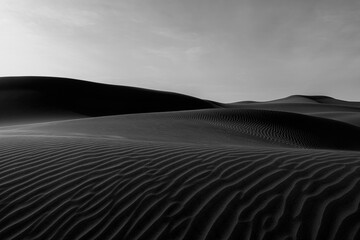 Black-and-white view of textured sand dunes near Huacachina Oasis, Peru.