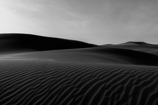 Black-and-white view of textured sand dunes near Huacachina Oasis, Peru. - Powered by Adobe