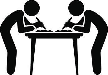 Two people writing at a table with pens and paper desk