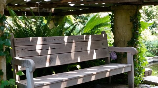 A wooden bench placed under a metal roof, ideal for rustic d&eacute;cor or outdoor settings