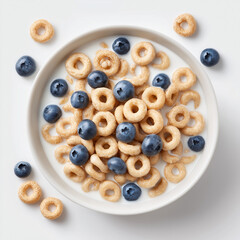 Top-down view of a white ceramic bowl with a small portion of dark chocolate cereal rings (Oreo-style texture), mostly submerged in fresh milk. Generous milk quantity, minimal cereal floating on top. 