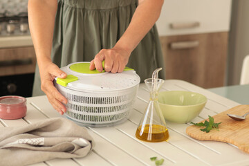 Woman open lid of herb dryer. Healthy eating and food. Mediterranean diet. Kitchen tools for cooking at home. 
