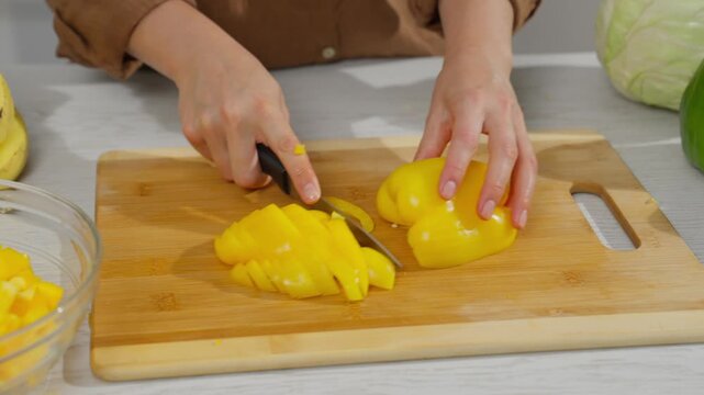 Cutting and preparing fruits and vegetables in the kitchen.