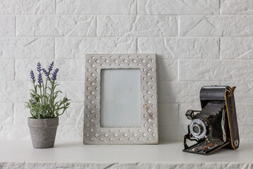 Home office concept. Empty wooden picture frame mockup. White wall background. Scandinavian interior design.