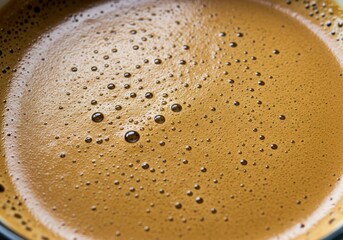 Close-up of rich, foamy coffee with bubbles, perfect for a morning beverage.