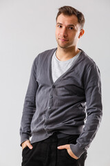 Confident and stylish. young man and looking at camera while standing against white background