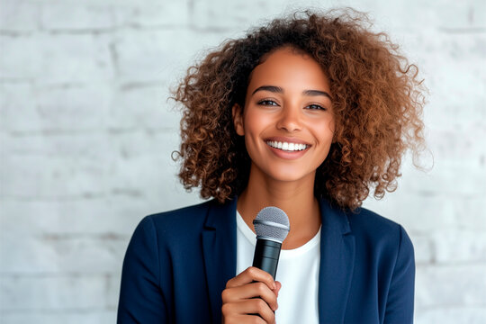 African American businesswoman speaking into a microphone at a conference, business meeting