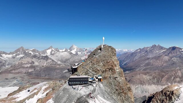 Aerial video of top of klein matterhorn and cable carts with a mountain range in the backgroud