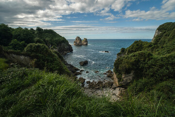 Steep cliffs, islets and wild hidden coves in the green and wild coast of Asturias, Northern Spain