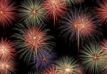 Naklejka premium Vibrant fireworks exploding in the night sky, celebrating holidays, festivals, and special events with dazzling light displays