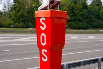 Close-up of metal orange SOS pole at highway A1 between Swiss cities of Zürich and Wallisellen on a cloudy autumn day. Photo taken October 2nd, 2025, Zurich Wallisellen, Switzerland.