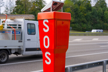Close-up of metal orange SOS pole at highway A1 between Swiss cities of Zürich and Wallisellen on a cloudy autumn day. Photo taken October 2nd, 2025, Zurich Wallisellen, Switzerland.