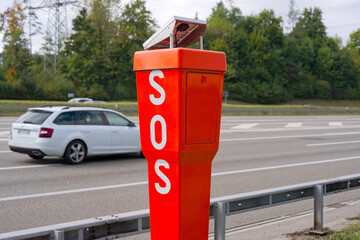 Close-up of metal orange SOS pole at highway A1 between Swiss cities of Zürich and Wallisellen on a cloudy autumn day. Photo taken October 2nd, 2025, Zurich Wallisellen, Switzerland.