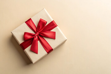 Wrapped christmas or other holiday handmade present in craft paper with colored ribbon. Present box, decoration of gift on table, top view with copy space.