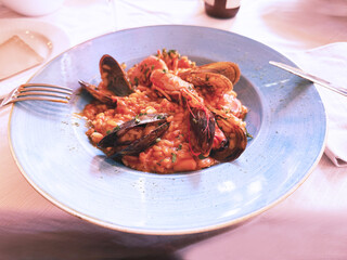Seafood paella. Traditional Spanish rice dishes in restaurants. Rice, prawns and mussels. Healthy eating on the Mediterranean Sea. Spain, Costa Blanca, Alicante.