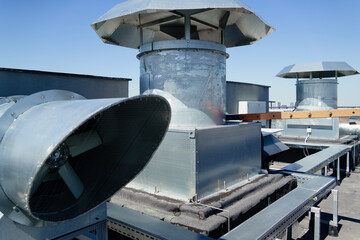 Ventilation HVAC system on the house roof. Steel pipes extractor hood home engineering