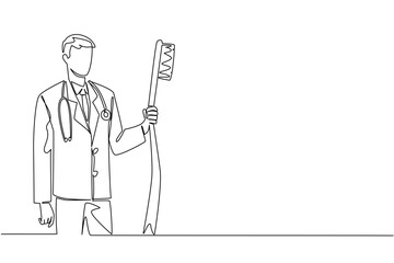 Single one line drawing male doctor in full medical attire holding big toothbrush. Provides directions on how to brush teeth properly. National Dentist Day. Continuous line design graphic illustration