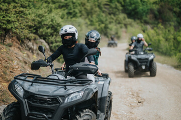 Friends ride quad bikes together along a picturesque forest trail, enjoying the excitement of outdoor adventure and the beauty of nature.