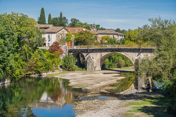 Scenic landscape view of Pont Neuf or New Bridge over Vidourle river in picturesque Sauve ancient village, Gard, France