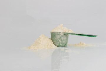Protein Powder with Plastic Scoop on White Background Nutrition Photostock