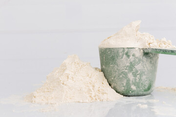 Protein Powder with Plastic Scoop on White Background Nutrition Photostock